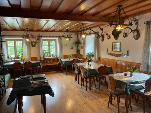 a dining room with tables and chairs in it at Ferienhof Zamsegg in Vordertambergau