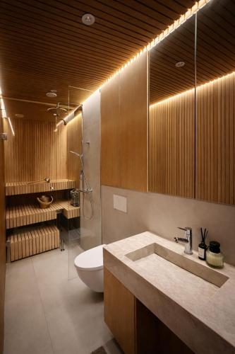 a bathroom with a sink and a toilet and a shower at Borderlake One in Ruka