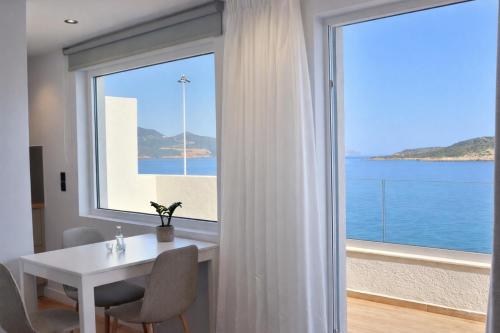 a dining room with a table and a large window at 9 Muses Apartments in Agios Nikolaos