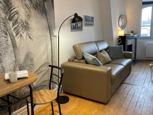 a living room with a couch and a table at Charmant studio Hyper centre in Dreux