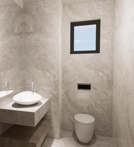a bathroom with a sink and a toilet and a window at Sam's Faliraki in Faliraki