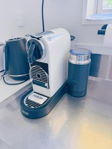 a coffee maker sitting on a counter with a cup at Bright Eden Park two bed townhouse private parking in Auckland