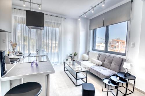 a living room with a couch and a table at Maison Poème Luxury Apartments in Aiándion