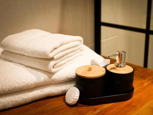 a pile of towels and a blow dryer on a table at The Roaming Goat Guesthouse in Toekoms