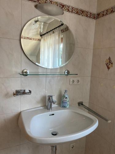 a white sink in a bathroom with a mirror at Gross Lettenwag in Göstling an der Ybbs