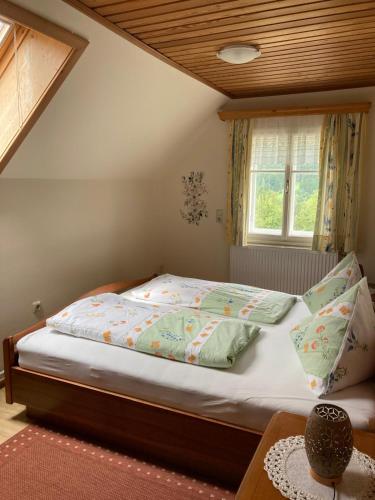 a bedroom with a bed with a wooden ceiling at Gross Lettenwag in Göstling an der Ybbs