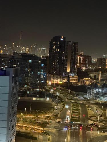 a city at night with traffic on a highway at TOP VIEW Luxury 2 bedrooms in Dubai only families in Dubai