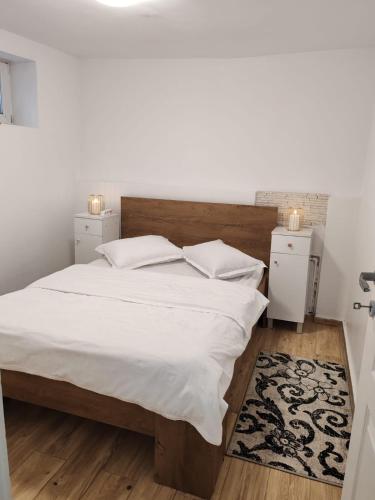 a bedroom with a large white bed with two night stands at Casa Muresan in Cluj-Napoca