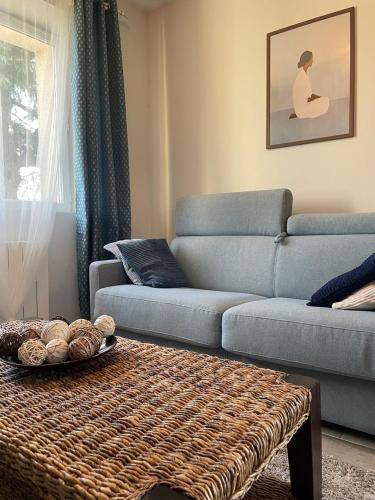 a living room with a couch and a table at Vert Bocage à Bâlines in Balines
