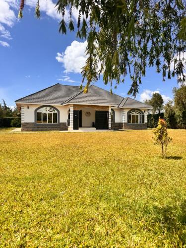 a house with a large yard in front of it at NAIBERi LUXURY HOME in Eldoret
