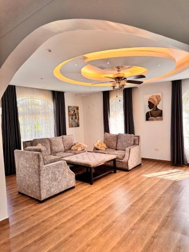 a living room with two couches and a table at NAIBERi LUXURY HOME in Eldoret