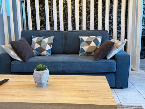 a blue couch with pillows on a porch at Grand T3 2 chambres avec vue sur la campagne à Bâlines in Balines