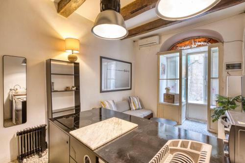 a kitchen with a table and chairs in a room at Archbishop Street Valletta Apartment in Valletta