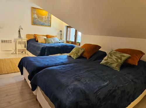 a bedroom with two beds with blue comforters at Łebska Ostoja - Zacisze in Żarnowska
