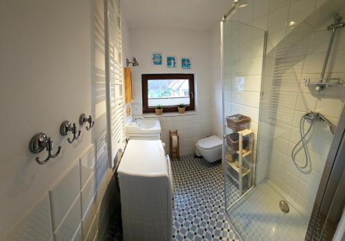 a bathroom with a toilet and a sink and a shower at Łebska Ostoja - Zacisze in Żarnowska