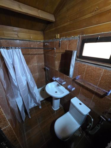 a bathroom with a toilet and a sink at Auberge RAMZ'S in Beni Mellal