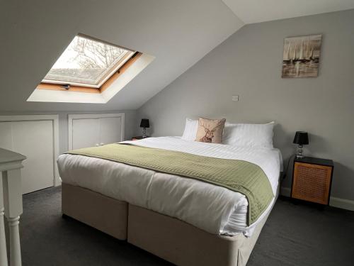 a bedroom with a large bed with a window at Pendle Inn in Barrowford