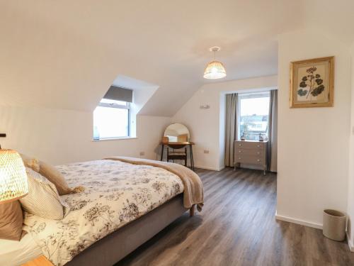 a bedroom with a bed and a window at The Kiln in Bolnhurst