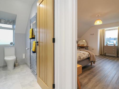 a bedroom with a bed and a toilet in a room at The Kiln in Bolnhurst