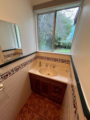 a bathroom with a sink and a window at Genesta House in Cowes
