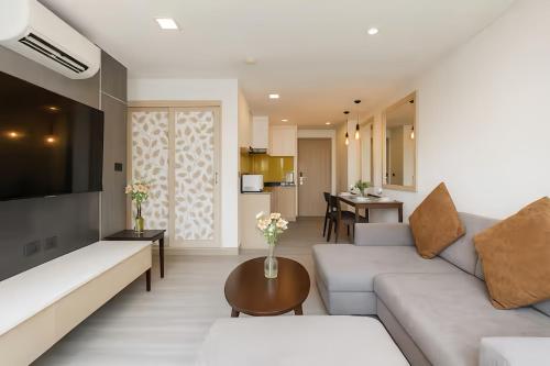 a living room with a couch and a table at Shine 43 Service Residence Bangkok in Bangkok