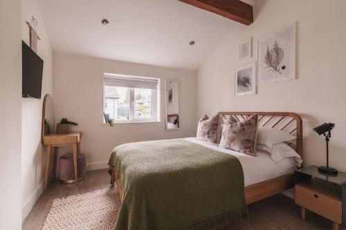 a bedroom with a bed and a window at Stylish accommodation - Bowness centre with parking space in Bowness-on-Windermere