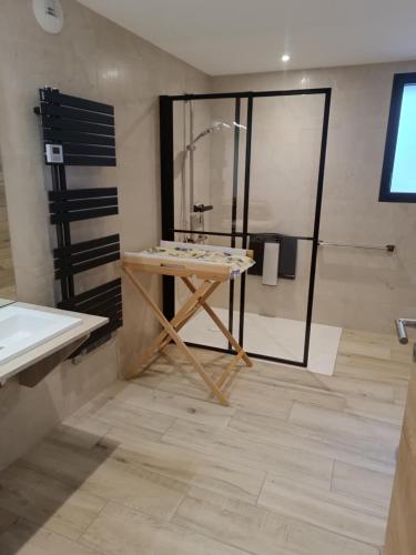 a bathroom with a wooden table and a shower at Gite du Châtelard in Thiébouhans