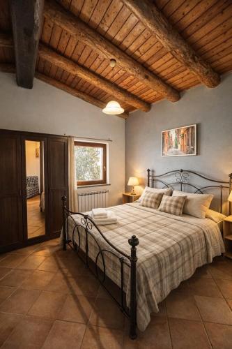 a bedroom with a large bed with a wooden ceiling at Altamarea Private Retreat in Corniglia
