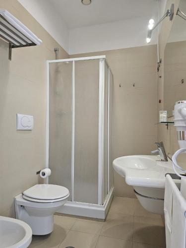 a bathroom with a shower and a toilet and a sink at Casa Rossa 1888 in Torre del Greco