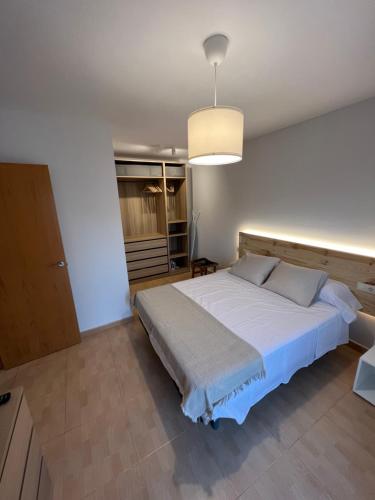 a bedroom with a large bed and a light fixture at Rincón Costero in Rincón de la Victoria