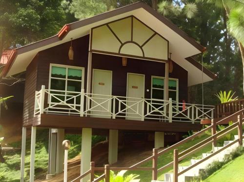 a small house with a porch and a balcony at Perkasa Mt Kinabalu , Sabah in Kampong Kundassan