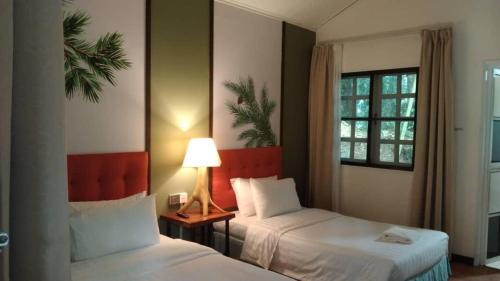 a hotel room with two beds and a window at Perkasa Mt Kinabalu , Sabah in Kampong Kundassan