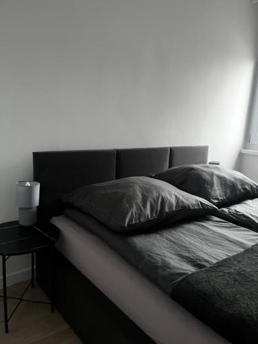 a black and white photo of a bed with pillows at Apartament Rynek Strzelin in Strzelin