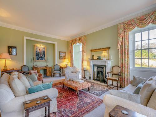 a living room with couches and a fireplace at Ladywell House in Falkland