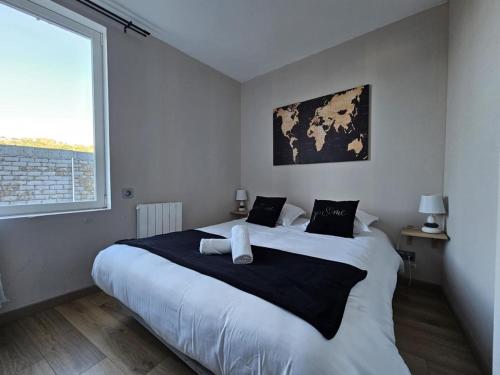 a bedroom with a large bed with a large window at Étretat, Alphonse Karr in Étretat