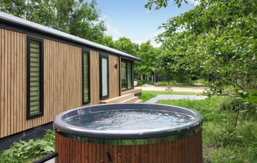 a large tub of water in front of a house at Sernets Recreatie Chalet 112 in Oud-Gastel