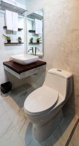 a bathroom with a white toilet and a sink at S2 Residence in Ao Nang Beach