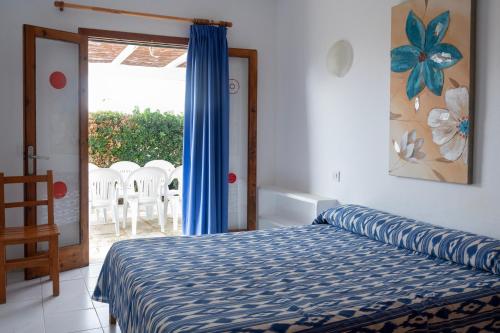 a bedroom with a bed and a sliding glass door at Villa Marta in Cala Blanca