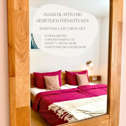 a mirror in a room with a bed with red pillows at Ferienhaus Landeskrone für 10 Personen mit Sauna, Terrasse, inkl Parkplatz in Dresden in Dresden