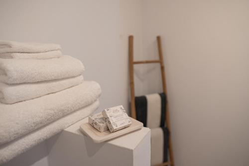 a pile of towels on a table in a bathroom at Vino Resort Son Amaret in Son Macia