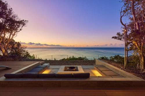 a fire pit with the ocean in the background at UMIBE Terrace in Shima