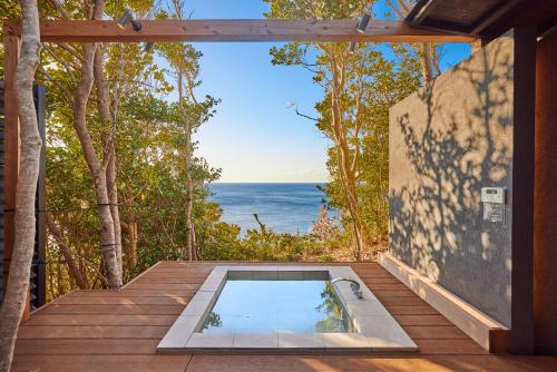 a plunge pool on a deck with a view of the ocean at UMIBE Terrace in Shima