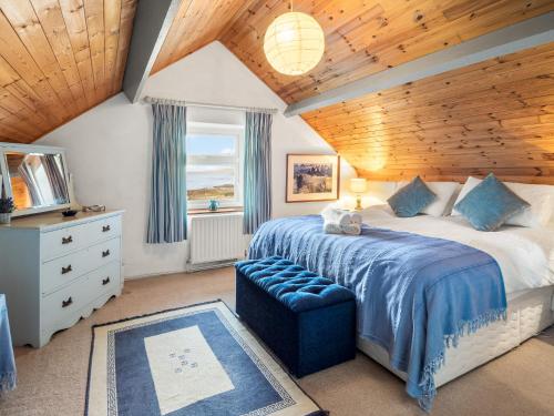 a bedroom with a large bed with a wooden ceiling at The Residence Renvyle in Renvyle