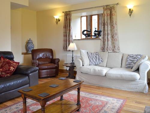 a living room with a couch and a coffee table at Bings Farm House in Whaley Bridge