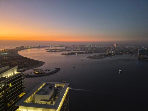 a view of a river at sunset from a building at Luxury Penthouse Retreat - Private Beach, Breathtaking Palm and Marina Views in Dubai