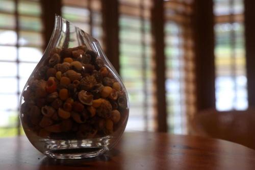 a glass vase filled with rocks sitting on a table at Penryn House Hotel in Polperro