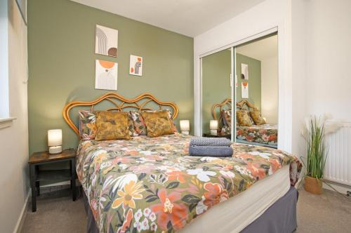 a bedroom with a large bed and a mirror at 2Bed City Central East End Gem with Free Parking in Glasgow