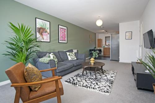 a living room with a couch and a table at 2Bed City Central East End Gem with Free Parking in Glasgow