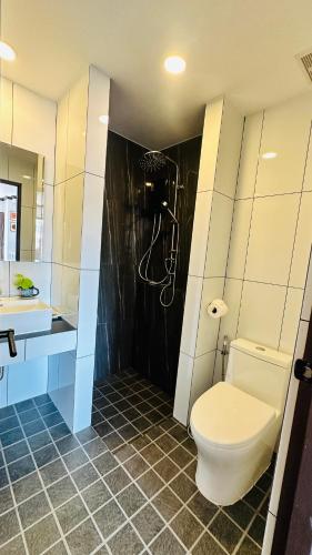 a bathroom with a toilet and a shower at Oh'tel Kata in Kata Beach