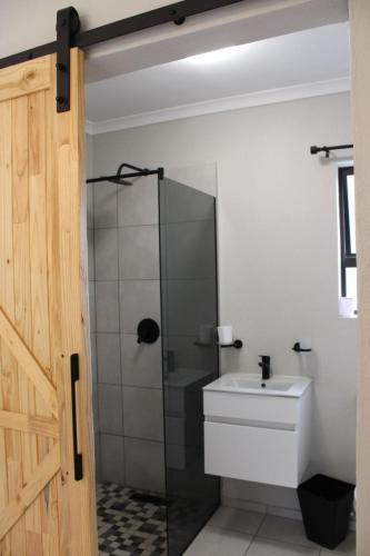 a bathroom with a shower and a sink at The White Castle in Chartwell